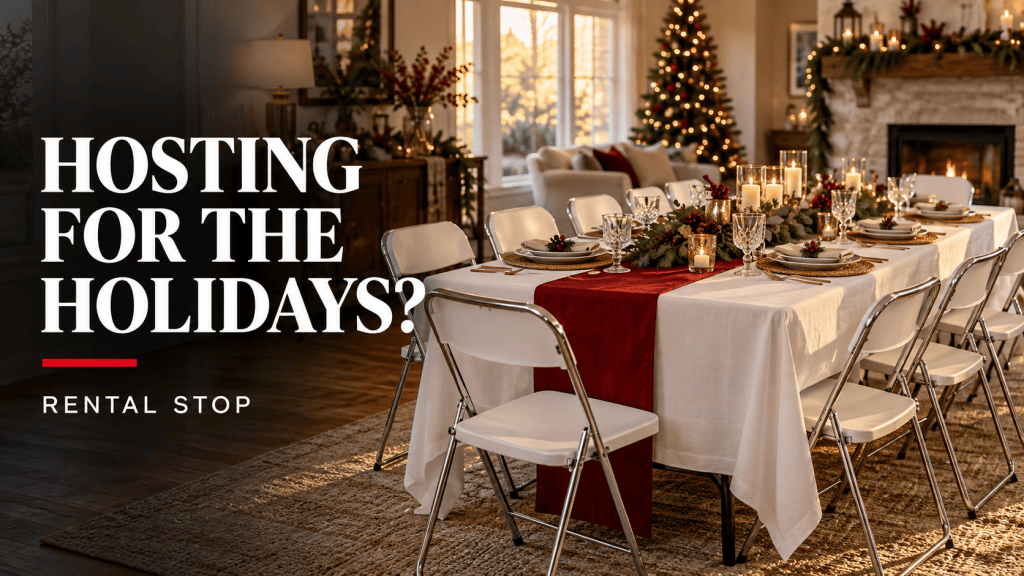 Table set for a holiday gathering with white tablecloths, decorative centerpiece, plates, and candles, in a cozy living room with a Christmas tree.